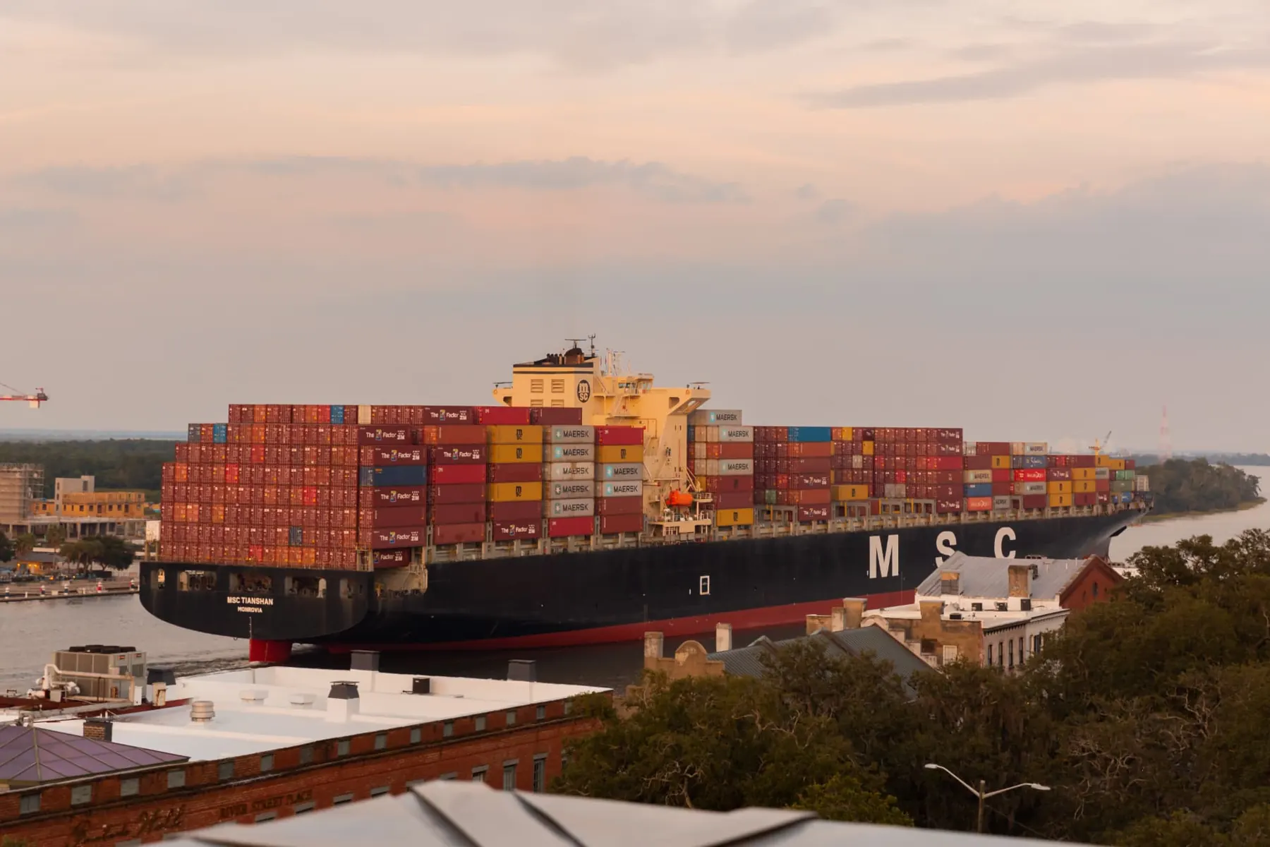 Container ship passing on the Savannah River at sunset