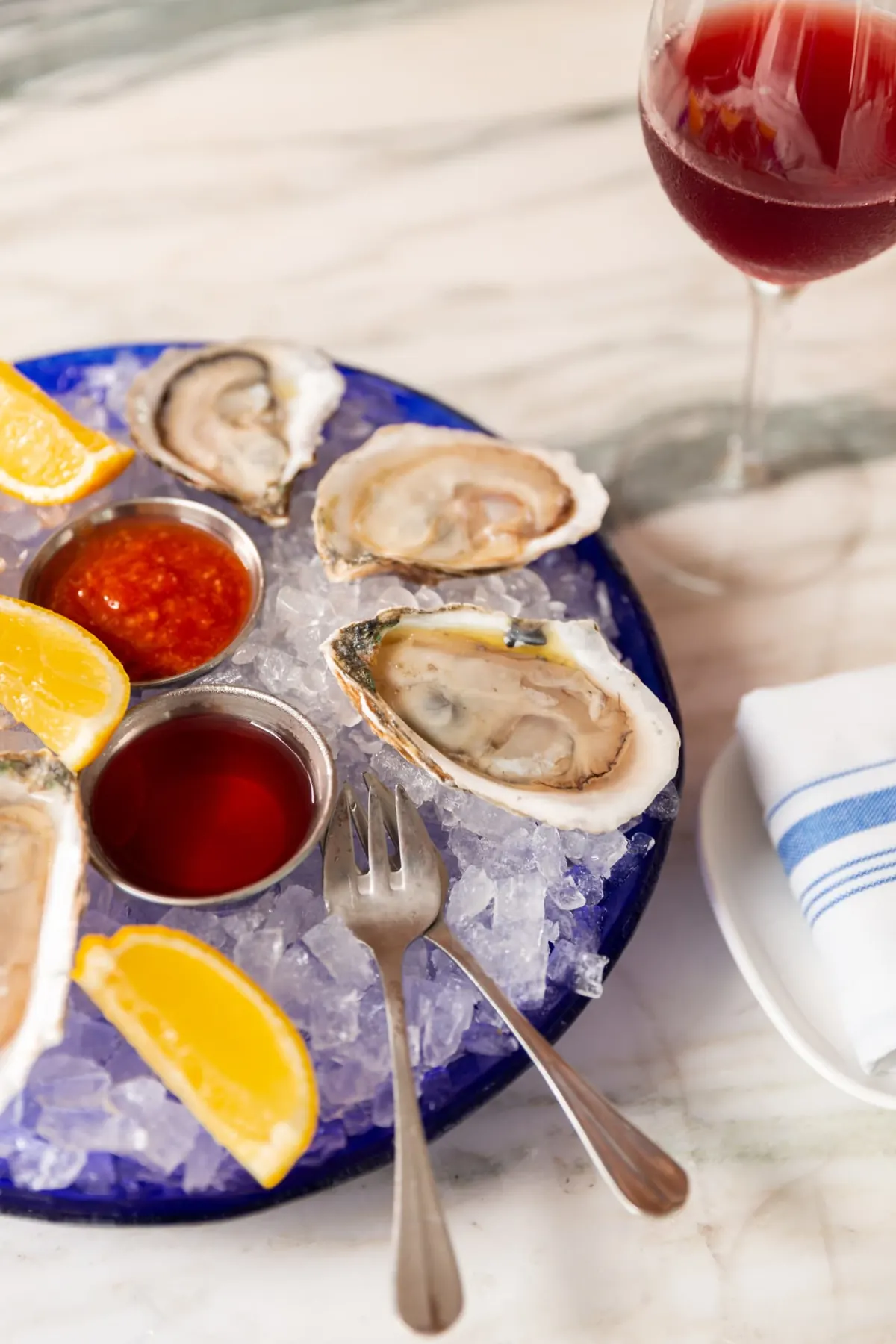 Close-up of oysters with cocktail sauce and red wine