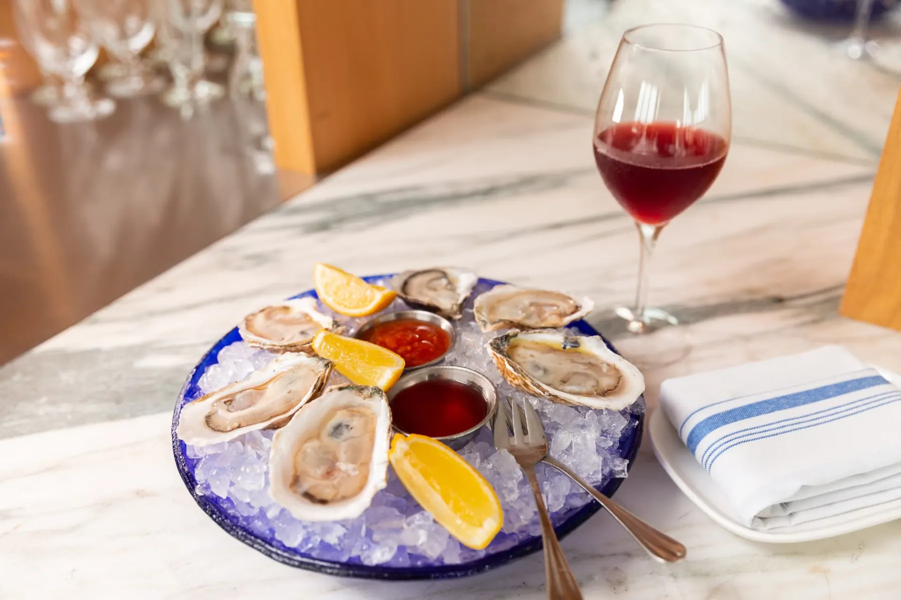 Oysters on ice with lemon and a glass of red wine